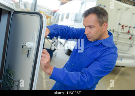 Mechanic working on camper van Stock Photo