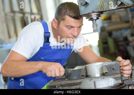 Engineer using bench drill Stock Photo