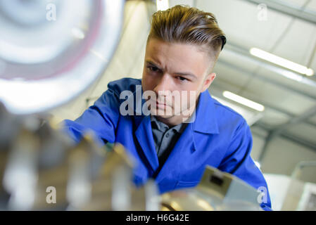 Closeup of young worker in overalls Stock Photo