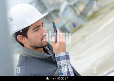 Construction worker using walkie talkie Stock Photo