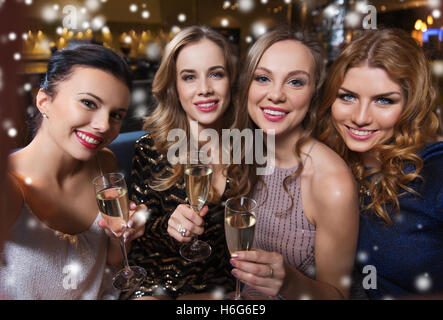 smiling women with champagne taking selfie at club Stock Photo