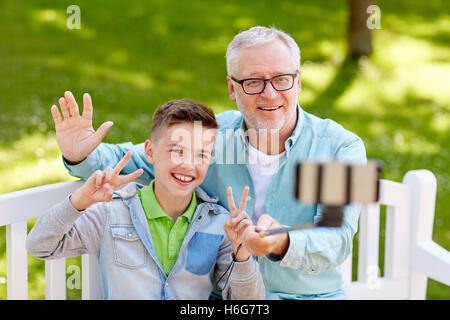 old man and boy taking selfie by smartphone Stock Photo