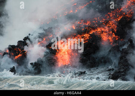 hot a'a lava from Kilauea Volcano, reaches the ocean at Kamokuna, Kalapana, Hawaii Volcanoes National Park Stock Photo