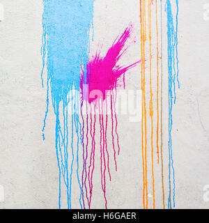white wall with colorful stains and flowing paint Stock Photo