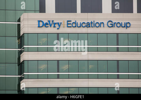 A logo sign outside of the headquarters of the DeVry Education Group in Downers Grove, Illinois on October 15, 2016. Stock Photo