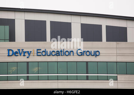 A logo sign outside of the headquarters of the DeVry Education Group in Downers Grove, Illinois on October 15, 2016. Stock Photo