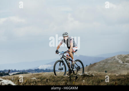 male cyclist mountainbiker on sports bike in mountains during Crimean race mountainbike Stock Photo