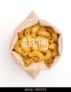 plenty of raw pasta in bag on white background Stock Photo