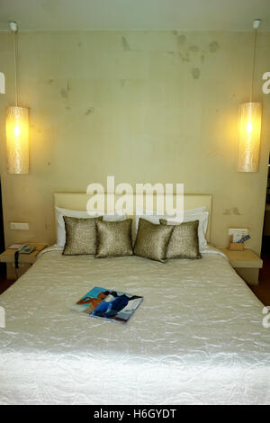 HERAKLION, CRETE, GREECE - MAY 13, 2014: Interior room with big bed, lamps and golden pillows in modern building of luxury hotel Stock Photo