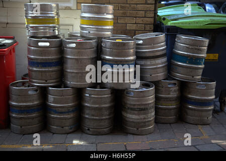 beer kegs stacked in alley for collection Stock Photo