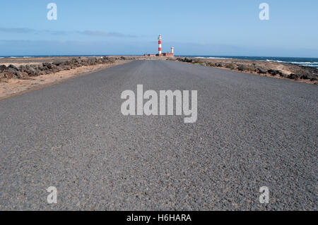 Fuerteventura, Spain: the asphalt and view of El Toston Lighthouse, whose original structure, in the northwest of the island, was opened in 1897 Stock Photo