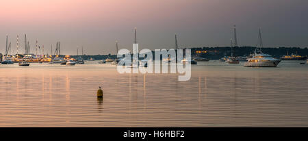 Yachts and lighthouse in Cannes at sunrise Stock Photo