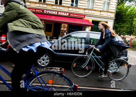 BERLIN - JUNE 16: Cyclers in the street on an inclement day on June 16, 2012 in Berlin, Germany. Stock Photo
