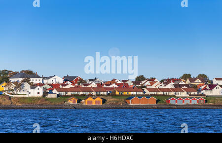 Colorful wooden houses stand on sea coast. Norway, Brekstad Stock Photo