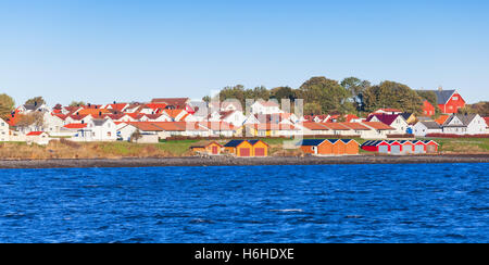 Colorful wooden houses stand on sea coast in Norway, Brekstad Stock Photo