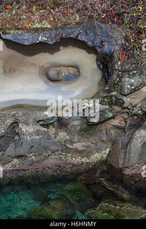 Abstract eroded sandstone formation in a tidal inlet on Galiano Island Stock Photo