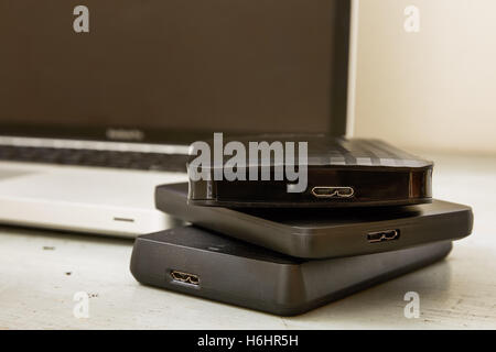 External Hard Disks and Laptop Keyboard on Wooden Table. Stock Photo