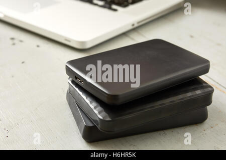 External Hard Disks and Laptop Keyboard on Wooden Table. Stock Photo