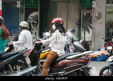 girls riding scooters mopeds in Ho Chi Minh saigon,Vietnam Stock Photo