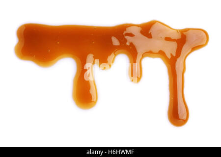 Melted caramel dripping isolated on white background Stock Photo