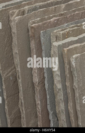 Slabs of Indian stone slate are piled up ready to use for laying a new patio. Stock Photo