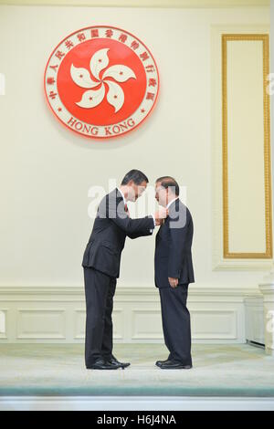 Hong Kong. 29th Oct, 2016. Leung Chun-ying (L), chief executive of the Hong Kong Special Administrative Region (SAR), confers the Grand Bauhinia Medal to Tam Yiu-chung, former president of the Democratic Alliance for the Betterment and Progress of Hong Kong, at the 2016 Honors and Awards Presentation Ceremony in Hong Kong, south China, Oct. 29, 2016. © Xinhua/Alamy Live News Stock Photo