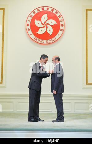 Hong Kong. 29th Oct, 2016. Leung Chun-ying (L), chief executive of the Hong Kong Special Administrative Region (SAR), confers the Grand Bauhinia Medal to Lo Chung Wing, Chairman of Gold Peak Group and former chairman of board of directors of Hong Kong Science and Technology Park, at the 2016 Honors and Awards Presentation Ceremony in Hong Kong, south China, Oct. 29, 2016. © Xinhua/Alamy Live News Stock Photo