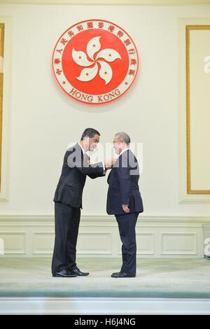 Hong Kong. 29th Oct, 2016. Leung Chun-ying (L), chief executive of the Hong Kong Special Administrative Region (SAR), confers the Grand Bauhinia Medal to Moses Cheng Mo-chi at the 2016 Honors and Awards Presentation Ceremony in Hong Kong, south China, Oct. 29, 2016. © Xinhua/Alamy Live News Stock Photo