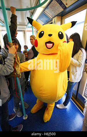 London, UK. 29th October 2016. Pikachu from Pokemon, aka 12 year old John from London, rides the DLR, Dockland Light Railway, to day two of MCM London Comic Con, one of the largest pop culture events in the UK taking place at Excel London. Credit:  Paul Brown/Alamy Live News