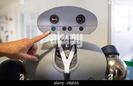 Karlsruhe, Germany. 09th Sep, 2016. Ruediger Dillmann, director of the Karlsruhe Institute for Technology (KIT), points to the head of a robot named 'Holly' in Karlsruhe, Germany, 09 September 2016. Photo: Christoph Schmidt/dpa/Alamy Live News Stock Photo