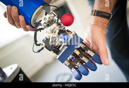 Karlsruhe, Germany. 09th Sep, 2016. Ruediger Dillmann, director of the Karlsruhe Institute for Technology (KIT), hold a robot hand next in Karlsruhe, Germany, 09 September 2016. Photo: Christoph Schmidt/dpa/Alamy Live News Stock Photo