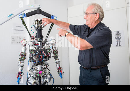 Karlsruhe, Germany. 09th Sep, 2016. Ruediger Dillmann, director of the Karlsruhe Institute for Technology (KIT), stands next to a robot in Karlsruhe, Germany, 09 September 2016. Photo: Christoph Schmidt/dpa/Alamy Live News Stock Photo