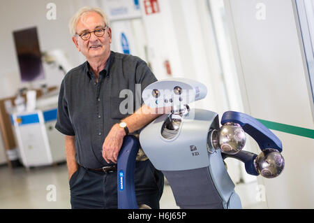 Karlsruhe, Germany. 09th Sep, 2016. Ruediger Dillmann, director of the Karlsruhe Institute for Technology (KIT), stands next to a robot named 'Holly' in Karlsruhe, Germany, 09 September 2016. Photo: Christoph Schmidt/dpa/Alamy Live News Stock Photo