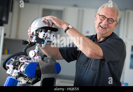 Karlsruhe, Germany. 09th Sep, 2016. Ruediger Dillmann, director of the Karlsruhe Institute for Technology (KIT), stands next to a robot identified as 'ARMAR IIIa' in Karlsruhe, Germany, 09 September 2016. Photo: Christoph Schmidt/dpa/Alamy Live News Stock Photo