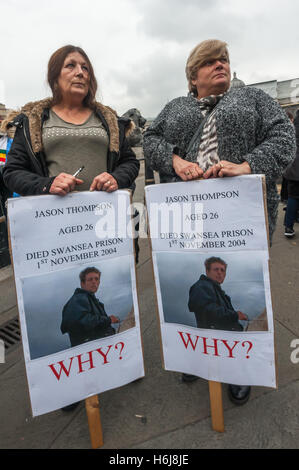 London, UK. 29th October 2016. Two women hold placards about the death of Jason Thompson, aged 26 in Swansea Prison on 1st Novemebr 2004. The Families and friends of people killed by police or in prisons wait for the start of their annual march at a funereal pace from Trafalgar Square to Downing St to hold a rally and deliver a letter to Theresa May. Peter Marshall/Alamy Live News Stock Photo