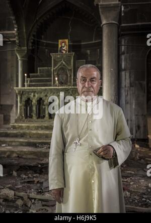 October 29, 2016 - Al Hamdaniyah, Nineveh Governorate, Iraq - Priest in front of altar in ruins of Al Hamdaniya Church. The church had been used for a hideout for Islamic State fighters (Credit Image: © Berci Feher via ZUMA Wire) Stock Photo