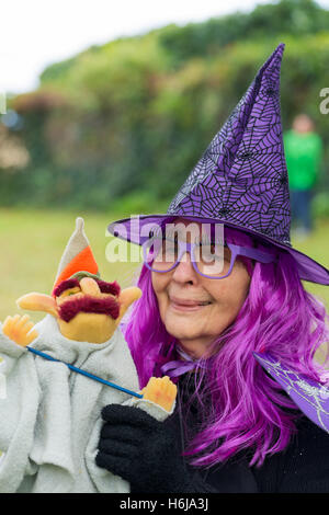 Merrick, New York, USA. 29th Oct, 2016. BETTY TUCKER, of Merrick, dressed as a witch and holding a wizard puppet, is at the 2016 annual Merrick Spooktacular hosted in part by the North and Central Merrick Civic Association (NCMCA). Betty is a member of the Merrick American Legion Auxilliary 1282, and the post sponsored the holiday party at Fraser Park. © Ann Parry/ZUMA Wire/Alamy Live News Stock Photo