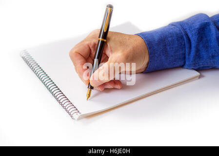man's hand writing with a fountain pen. isolated Stock Photo