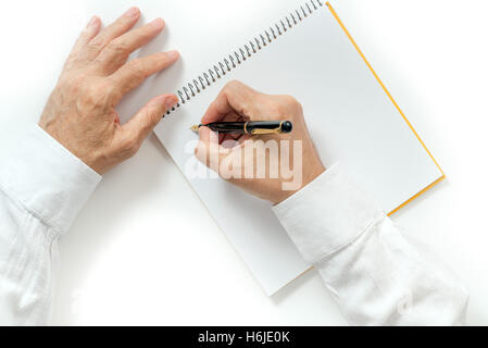 man's hand writing with a fountain pen. isolated Stock Photo