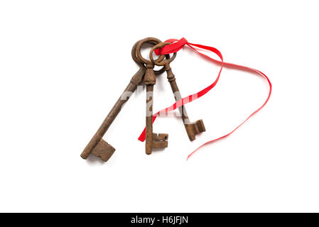 Three old rusty keys isolated on white. Stock Photo