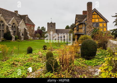 The timber-framed gatehouse at Stokesay Castle, with St John the Baptist church near Craven Arms, Shropshire, England, UK Stock Photo