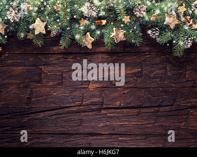 Christmas decoration with fir branches placed on old wooden planks. Stock Photo