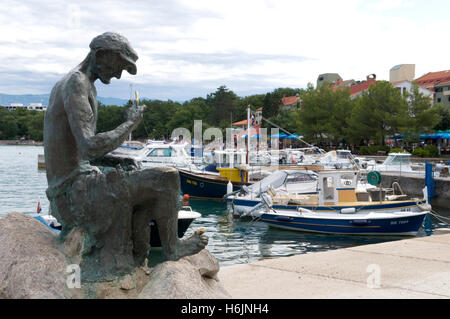 Fisherman sculpture in the port, Njivice, Krk island, Kvarner Gulf, Croatia, Europe Stock Photo