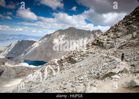 A single hiker on the long, John Muir Trail leading up to Mt. Whitney in the Sierra Mountains of California. Stock Photo