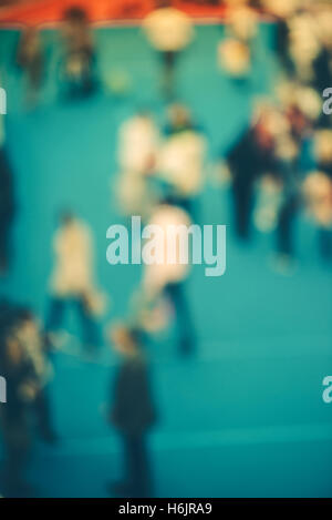 Abstract blurred people attending event in exhibition hall, press conference or celebration party, visitors of indoor fair Stock Photo