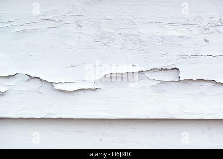 Cracked white paint on plank surface, abstract wooden background Stock Photo