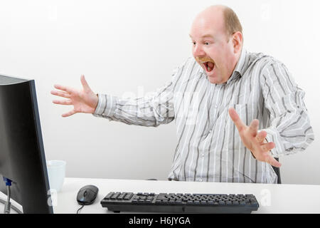 Surprised Businessman Gesturing While Looking At Computer Stock Photo