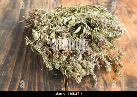 Summer Savory , Satureja Hortensis, on Rustic Wooden Background. Stock Photo