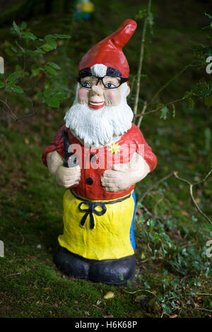 garden gnome in glasses and holding a pipe Stock Photo