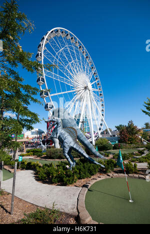 The Skywheel seen next to Dinosaur Adventure Golf a 70,000 sq foot dinosaur themed mini golf attraction in Niagara Falls Canada Stock Photo